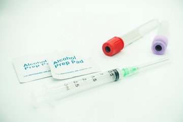 Blood taking kit, Empty syringe with needles, blood container tube and alcohol swab against...