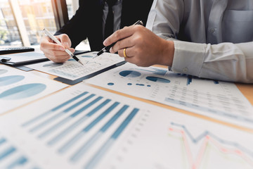 Business Corporate team brainstorming, Planning Strategy having a discussion Analysis investment researching with chart at office his desk documents and saving concept