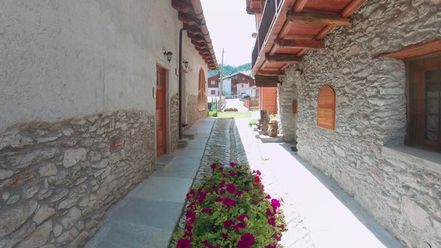 Flower pot on a corridor of a medieval town. The Alps houses with decoration. 4k