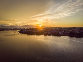 scenic aerial view of Sarawak River during sunset with Gunung (mountain) Serapi at the background © MuhammadFadhli