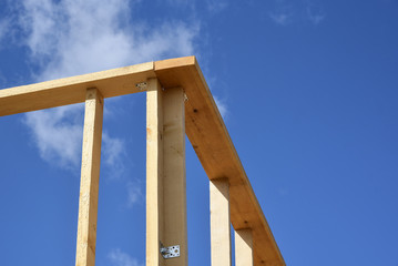 Wood frame residential building under construction.Building construction, wood framing structure at new property development site.new home currently under construction against blue sky.mortgage, loan.