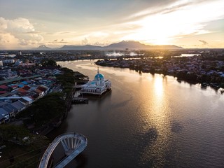 scenic aerial view of Sarawak River during sunset with Gunung (mountain) Serapi at the background © MuhammadFadhli