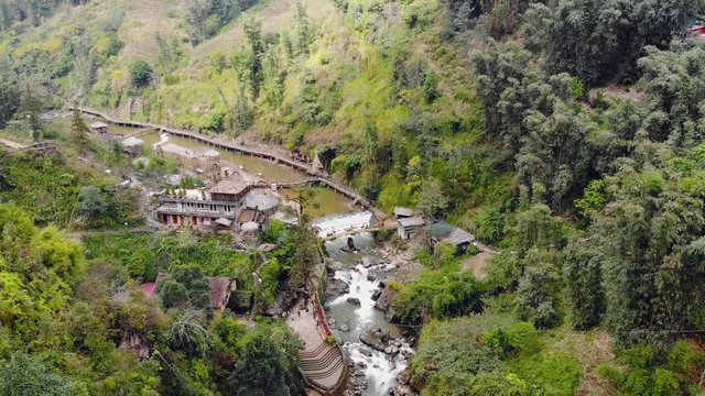 Aerial view of green terraced rice fields and building on the valley at Cat Cat village in Sapa, Vietnam. fly