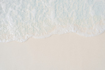 Fototapeta na wymiar Light blue sea wave on sand.