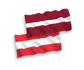 National vector fabric wave flags of Latvia and Austria isolated on white background. 1 to 2 proportion.