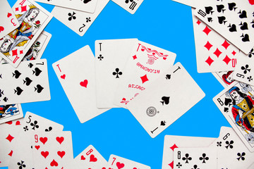 Playing card. Hand with card playing poker .close up of male hand with playing cards and chips at home. Pocker game. Casino cards as background. Concept for games, gambling in casino and sports poker.
