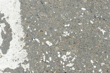 White paint on the old asphalt closeup. Abstract background