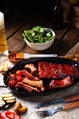 Grilled ribs in spicy marinade with salad and vegetables