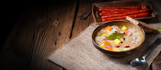 rustic sauerkraut soup with bacon and sausage