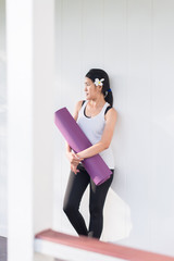 Sporty asian female hands holding yoga mat after a workout,Exercise equipment,Healthy fitness and sport concept