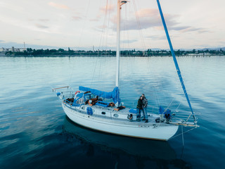 Happy Couple Hug while on the Deck of their Sailboat while Anchored