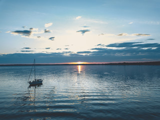 Sailboat Anchored on the Water during Sunset