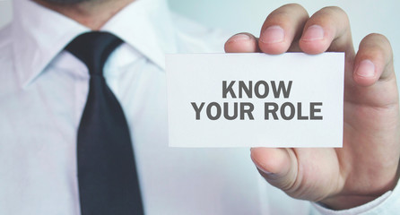 Businessman holding business card. Know Your Role