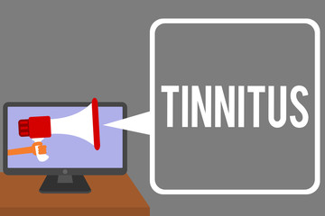 Conceptual hand writing showing Tinnitus. Business photo showcasing A ringing or music and similar sensation of sound in ears Man holding Megaphone computer screen talking speech bubble