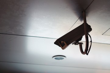 CCTV security camera installed on aluminum ceiling 