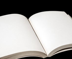 Open blank book on black background