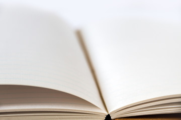 Open blank notebook closeup view