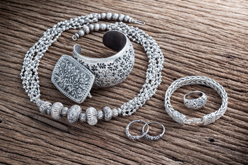 Collection of antique traditional silver jewelry on old wood