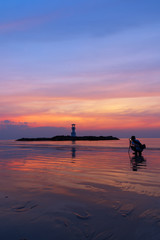 Silhouettes photographer and tourists in the evening sunset viewpoint,Lighthouse. Khao Lak, Phang Nga, Thailand.