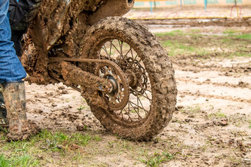 Fototapeta na wymiar Dirt from under the wheels of a motorcycle close-up