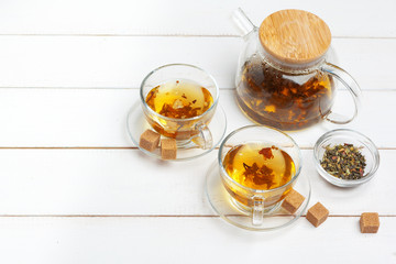 teapot and cups of tea on a white wooden background