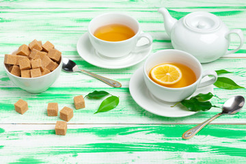 Black tea on green wooden background