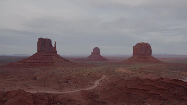 FIXED Cars passing by red rock formations in Monument Valley, Arizona, USA. 4K UHD 60 FPS SLOW MOTION