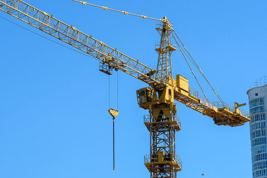 image of a tower crane at the construction site of a residential house