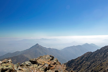 Mountain summit view with landscape of Andes and Aconcagua on clear day in La Campana National park in central Chile, South America