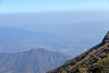 Obraz premium Mountain summit view with landscape of Andes and Aconcagua on clear day in La Campana National park in central Chile, South America
