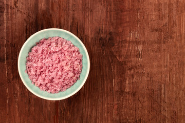 Obraz na płótnie Canvas Pink Himalayan sea salt, shot from the top on a dark rustic wooden background with a place for text