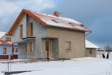 Deployed new modern house without parget  in village in winter