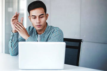 Young Businessman Working on Computer Laptop in Office. Sitting on Desk, Concentrated Thoughtful Men