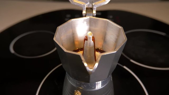 Making coffee on stovetop with a classic espresso maker, 4k moving image sliding left to right