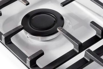 The hob burner is on a white gas stove