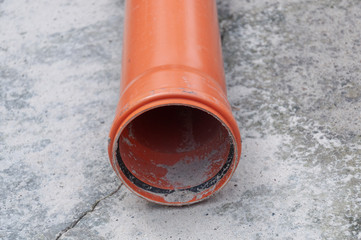 Sewer pipe on concrete background