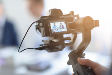 Professional videomaker shooting a video