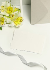 Mockup business cards on white background, fresh flowers and frame