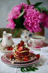 Pancakes with acacia flowers and strawberry chia sauce