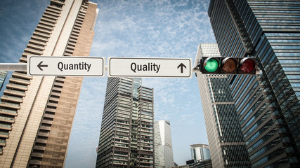 Fototapeta na wymiar Street Sign to Quality versus Quantity