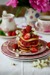 Pancakes with acacia flowers and strawberry chia sauce