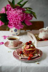 Pancakes with acacia flowers and strawberry chia sauce