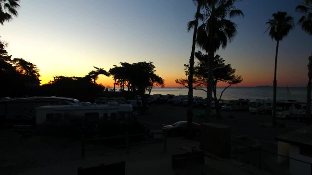 Ocean sunrise and Palm trees at a RV campground on the beach.