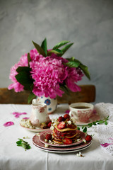Pancakes with acacia flowers and strawberry chia sauce