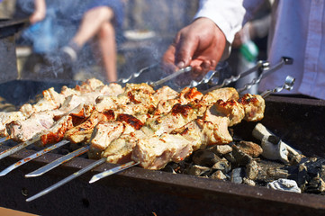 Cooking kebabs on hot coals on the grill