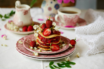 Pancakes with acacia flowers and strawberry chia sauce