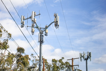 A modern cell tower with a cloudy sky background