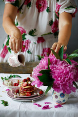 Pancakes with acacia flowers and strawberry chia sauce