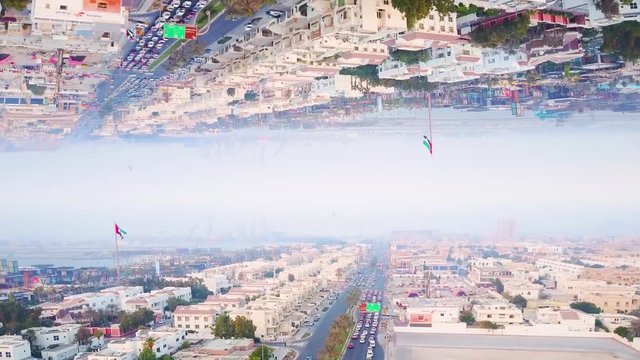 Modern city with mirror effect. Stock footage. Abstract animation with effect of parallel reality of reflected metropolis. Top view of city panorama mirrored from above like parallel worlds