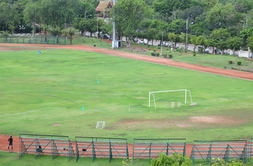 Scenery of football field and sport complex among natural surrounding. 